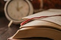 Opened book on a pile of old books.  Study education concept. Clock in backround. Royalty Free Stock Photo