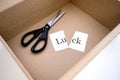 Opened the box and there are scissors and the word luck is cut into two parts
