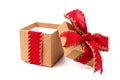 Opened brown gift box with red bow and ribbon isolated on white