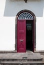 Opened burgundy door of a house Royalty Free Stock Photo