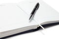 Opened business diary with a pen over white