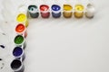 Opened cans with different paints on a white background