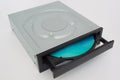 Opened CD - DVD drive with a black cap and blue disk.