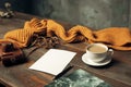 Opened craft paper envelope , autumn leaves and coffee on wooden table Royalty Free Stock Photo