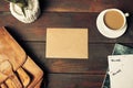 Opened craft paper envelope , autumn leaves and coffee on wooden table