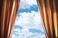 Opened curtain with blue sky