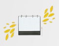 Opened day planner with yellow petals and pencil, on grey background. Flat lay. Workspace with checkered sheet, place for text Royalty Free Stock Photo