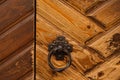 Opened door with ancient style carved knocker Royalty Free Stock Photo
