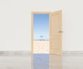 Opened door of beach villa overlooking sea in sunlight Royalty Free Stock Photo