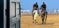 Opened door concept with a couple of rider on the beach on a blurred background Royalty Free Stock Photo
