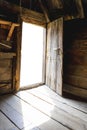 Opened door of an old wooden cottage with white blank space for your photo Royalty Free Stock Photo