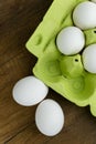 Opened egg box with ten eggs inside  on a wooden background. Fresh organic chicken eggs in carton or egg container. Royalty Free Stock Photo