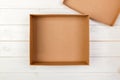 Opened empty cardboard box on wooden background. Top view Royalty Free Stock Photo