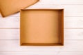 Opened empty cardboard box on wooden background. Top view vintage, toned Royalty Free Stock Photo