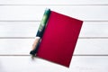 Opened the empty dark red mock up magazine page on white wooden Royalty Free Stock Photo
