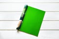 Opened the empty green mock up magazine page on white wooden ta Royalty Free Stock Photo