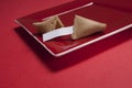 Opened Fortune Cookie on Square Red Plate Royalty Free Stock Photo