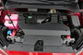 Opened front trunk with visible cover of electric engine on modern battery electric small family car MG 4 EV