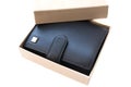 An opened gift box with a good, expensive wallet made of black genuine leather Royalty Free Stock Photo