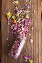 Opened glass bottle with dry mix of flowers