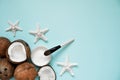 Opened glass jar with fresh coconut oil and ripe coconuts on blue background. Homemade coconut products Royalty Free Stock Photo