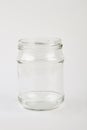 Opened glass jar, white background.