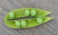 Opened green pod with peas inside close-up