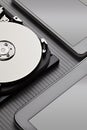 Opened hard disk drive and modern mobile devices on carbon background Royalty Free Stock Photo