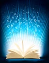 Opened magic book with magic light Royalty Free Stock Photo