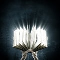 Opened magic book with magic lights Royalty Free Stock Photo