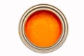 Opened metal can with orange paint top view, isolated on white