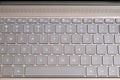 Opened modern laptop keyboard with USA alphabet on keys front top view closeup