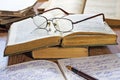 Opened notebook, pen, books and glasses Royalty Free Stock Photo