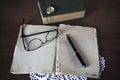 Opened notebook, pen, books and glasses Royalty Free Stock Photo