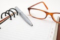 Opened notebook with pen and glasses Royalty Free Stock Photo