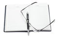 Opened notebook with pen and glasses Royalty Free Stock Photo