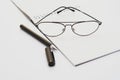 Opened notebook with pen and glasses isolated Royalty Free Stock Photo