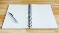 Notebook and pen on wooden desk Royalty Free Stock Photo