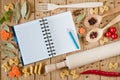 Opened notebook for recipes, vegetables and spices on a wooden table Royalty Free Stock Photo