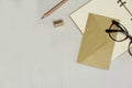 The opened notebook, pencil, sharpener, envelope, spectacles on the white background
