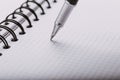 Opened notepad in a cage with an automatic plastic ballpoint pen close-up. toned Royalty Free Stock Photo