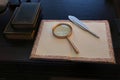 Opened an old blank book with magnifying glass on a wooden table Royalty Free Stock Photo