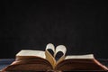 Opened old book with hart shaped from two pages Royalty Free Stock Photo