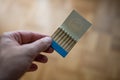 Opened old vintage box of un-burned matches held in hand by Caucasian male. Close up shot, shallow depth of field, no face Royalty Free Stock Photo