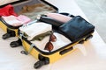 opened packed suitcase on bed in hotel room Royalty Free Stock Photo