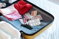 opened packed suitcase on bed in hotel room Royalty Free Stock Photo