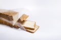 Opened plastic bag full of slices of white bread on the white background.Morning toasts and fresh soft bread