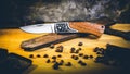 Opened pocket knife over a vintage ruler on the wooden surface Royalty Free Stock Photo