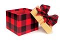 Opened red and black buffalo plaid Christmas gift box with lid and bow isolated on white Royalty Free Stock Photo