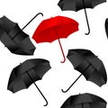Opened red and black umbrellas on white background